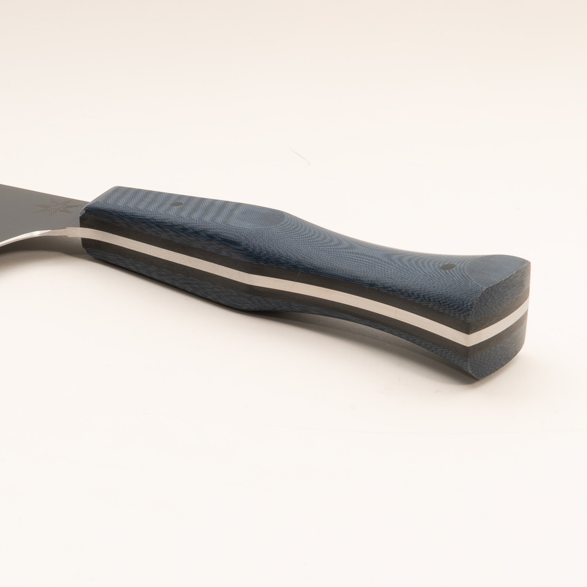 Detail photo of handle of stainless steel eXo Blue chef knife with blue linen micarta handle by Town Cutler. 