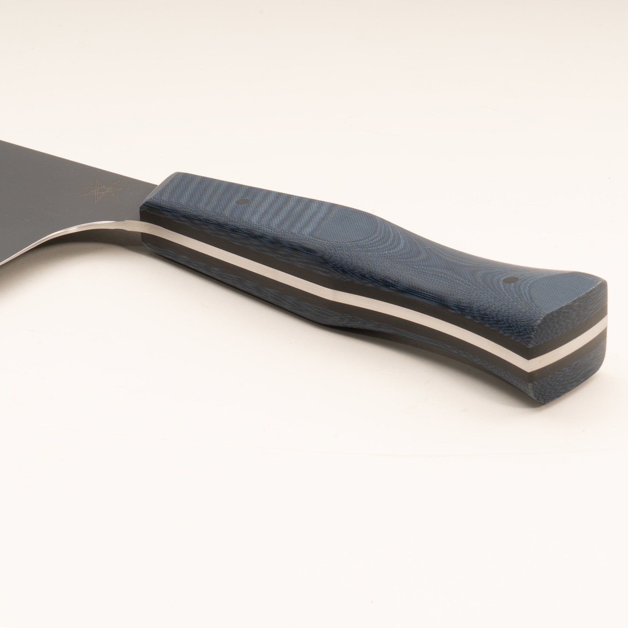 Detail photo of handle of stainless steel eXo Blue chopper knife with blue linen micarta handle by Town Cutler. 