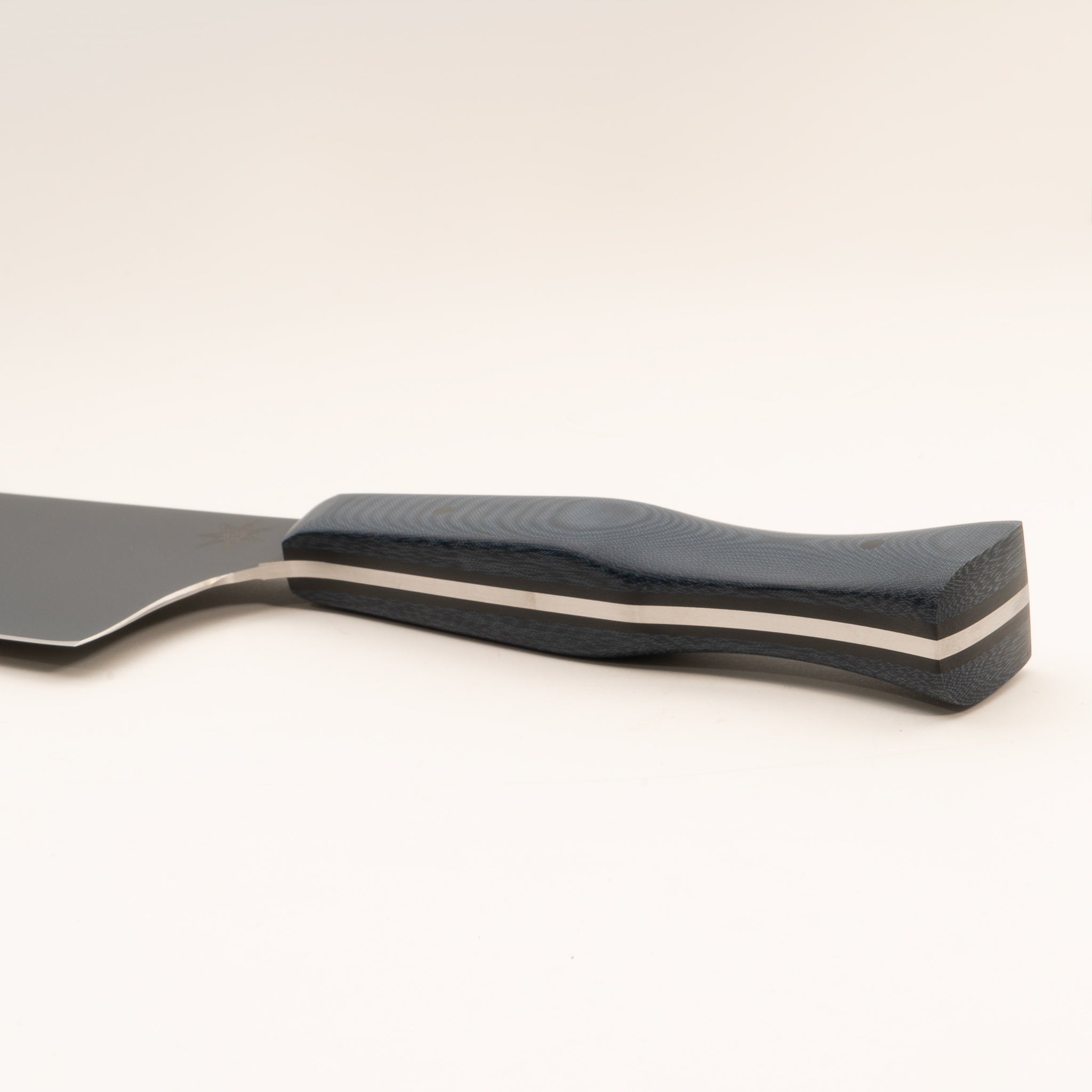 Detail photo of handle of stainless steel eXo Blue nakiri vegetable knife with blue linen micarta handle by Town Cutler. 