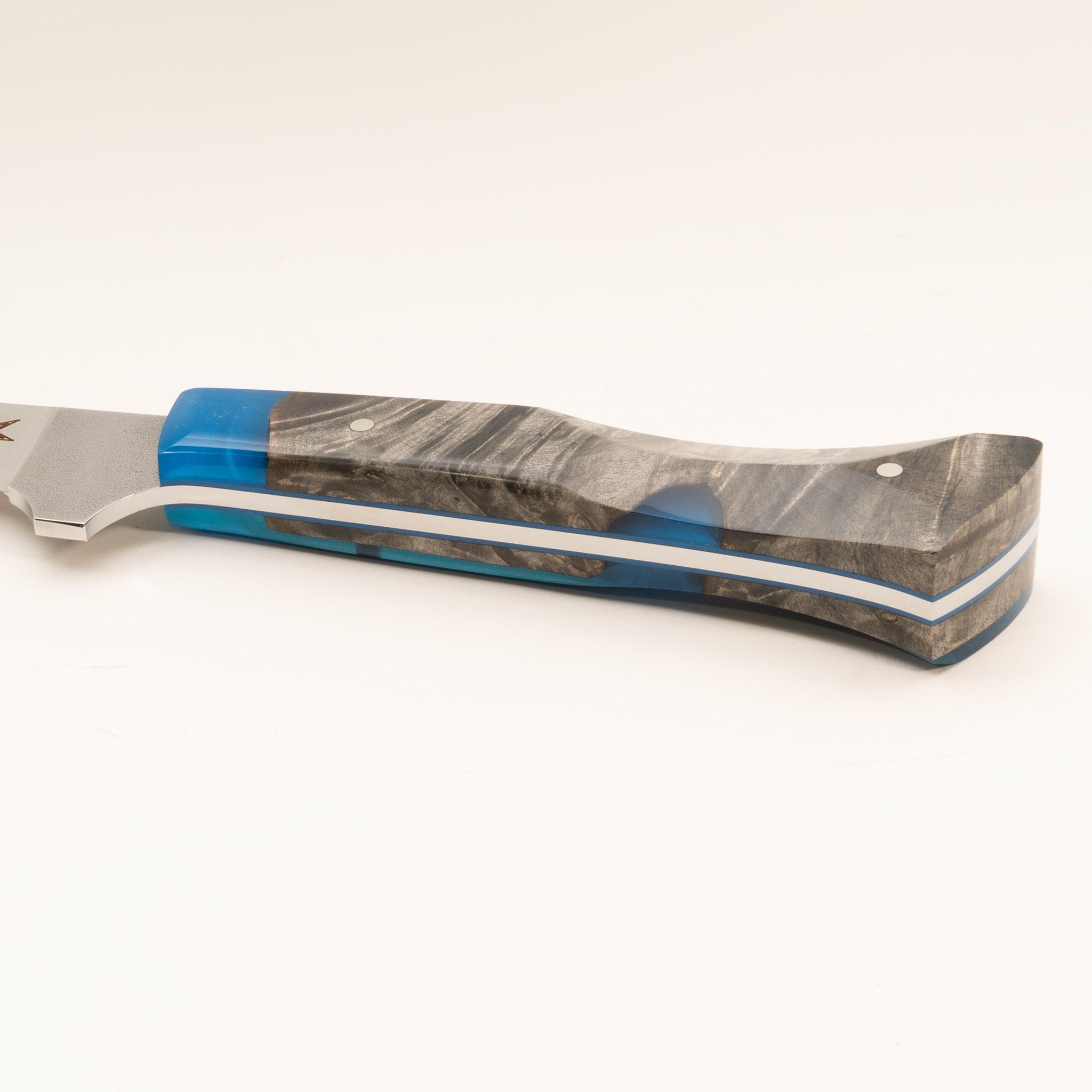 Detail photo of knife handle of Tahoe Bliss stainless steel straight boning knife with buckeye burl wood and blue resin handle by Town Cutler.