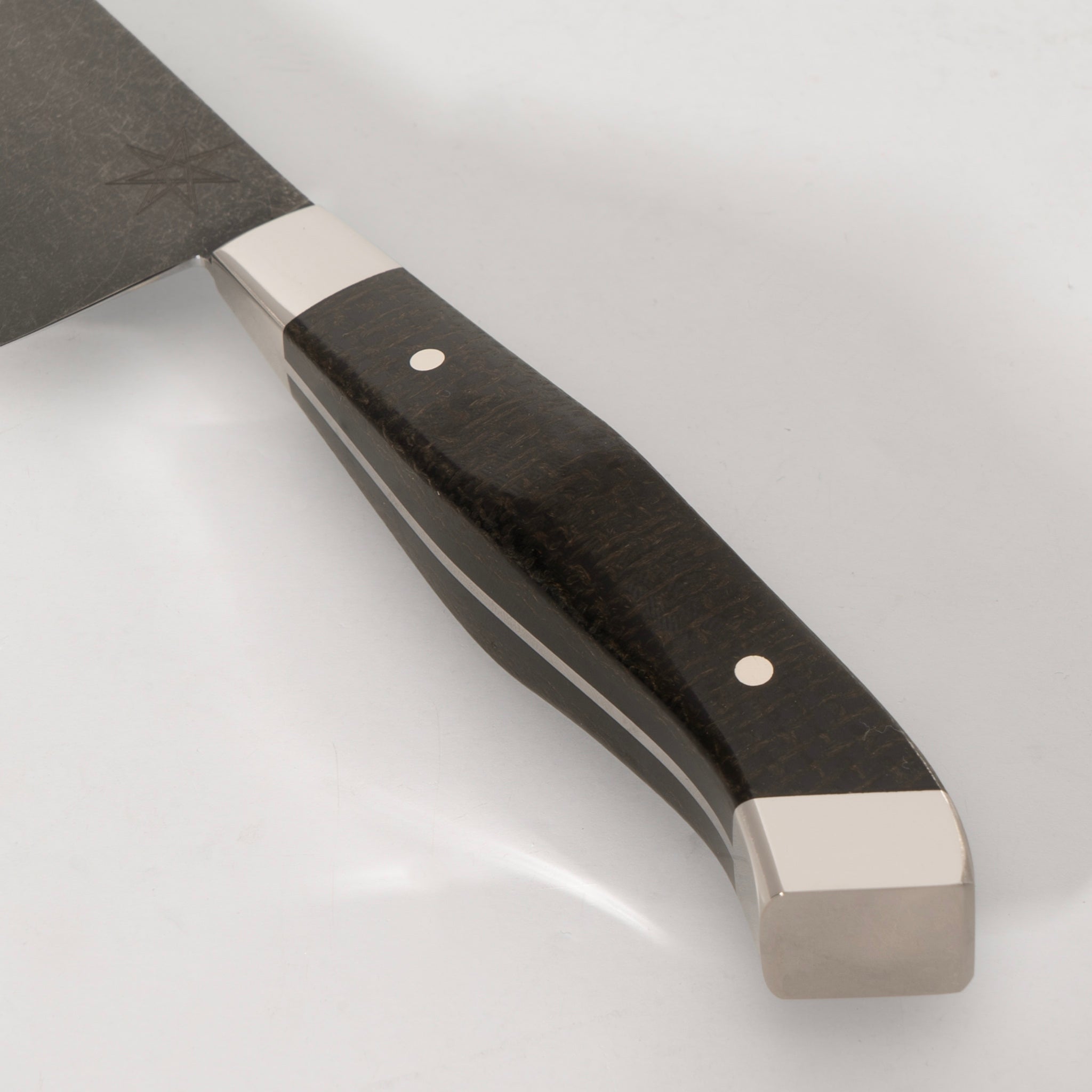 Detail photo of handle on 6" Carbon Steel Utility Knife with Stonewash Finish Blade, Black Burlap Micarta Handle, Stainless Steel Bolster and Pommel by Town Cutler