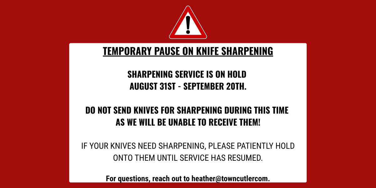 A red and white digital notice card with a warning triangle icon at the top and text stating a temporary pause on knife sharpening, with service held from August 31st to September 20th.